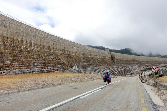 Cycling in front of the dam at Lagoa Comprida, Portugal